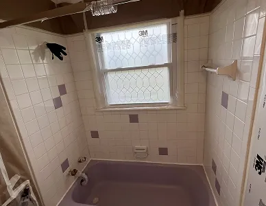 a bathroom with a tub and shower